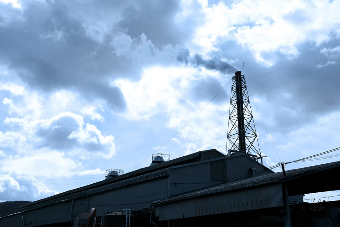 工場の煙突と空に広がる雲
